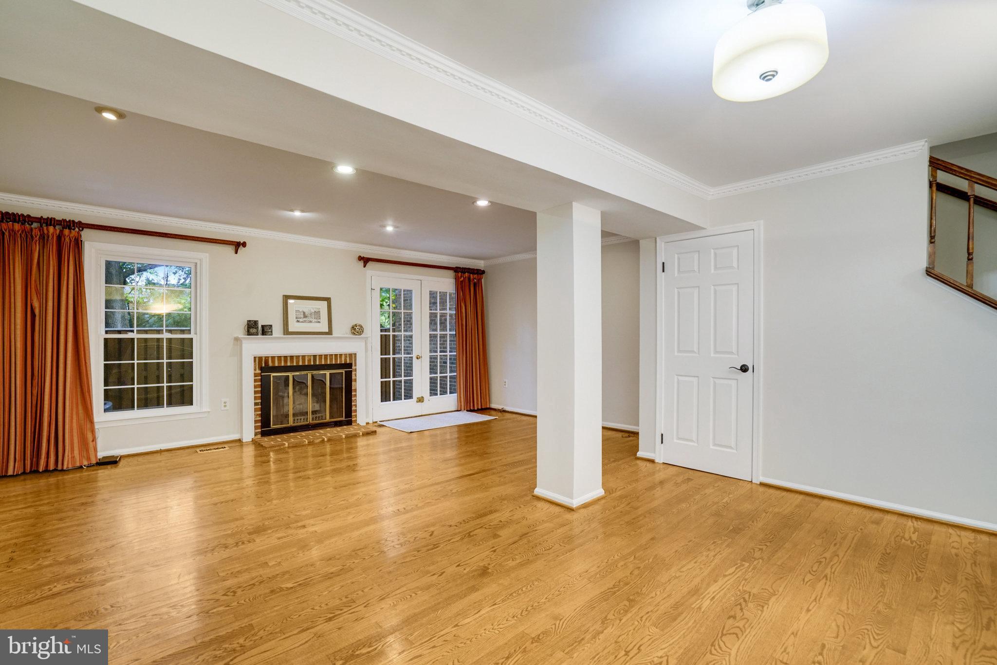 2540 South Walter Reed Drive, Unit 4 Arlington, VA 22206 - Photo 14 of 40 a view of an empty room with a fireplace and a window