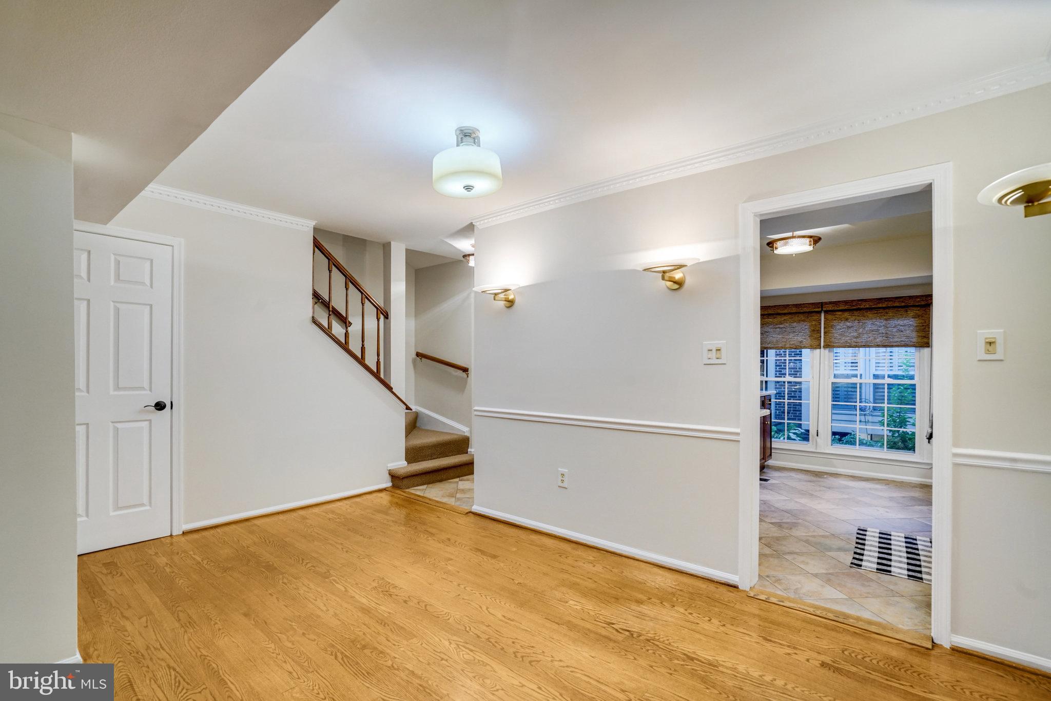 2540 South Walter Reed Drive, Unit 4 Arlington, VA 22206 - Photo 15 of 40 a view of a livingroom with wooden floor and stairs