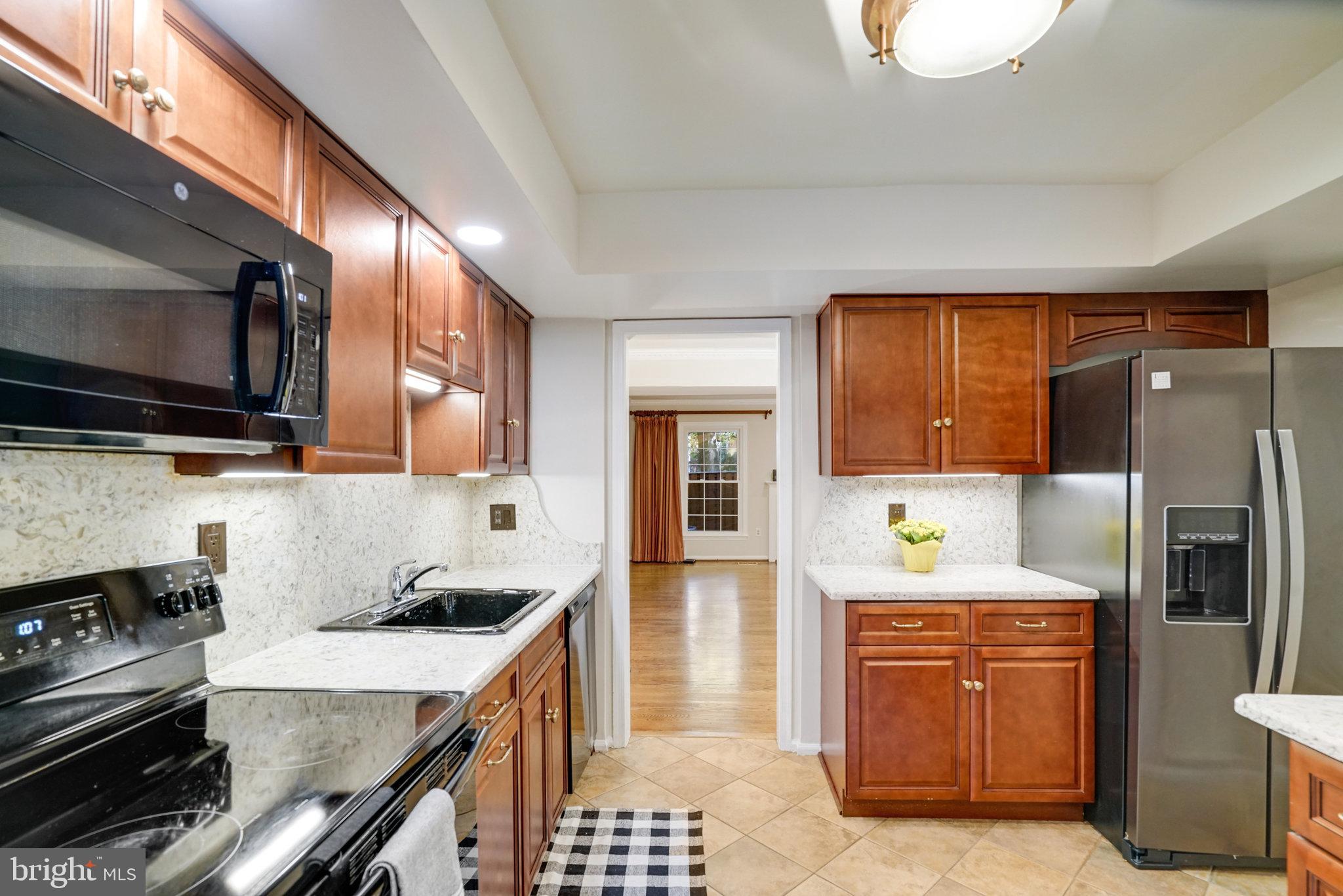 2540 South Walter Reed Drive, Unit 4 Arlington, VA 22206 - Photo 19 of 40 a kitchen with a sink stove and refrigerator