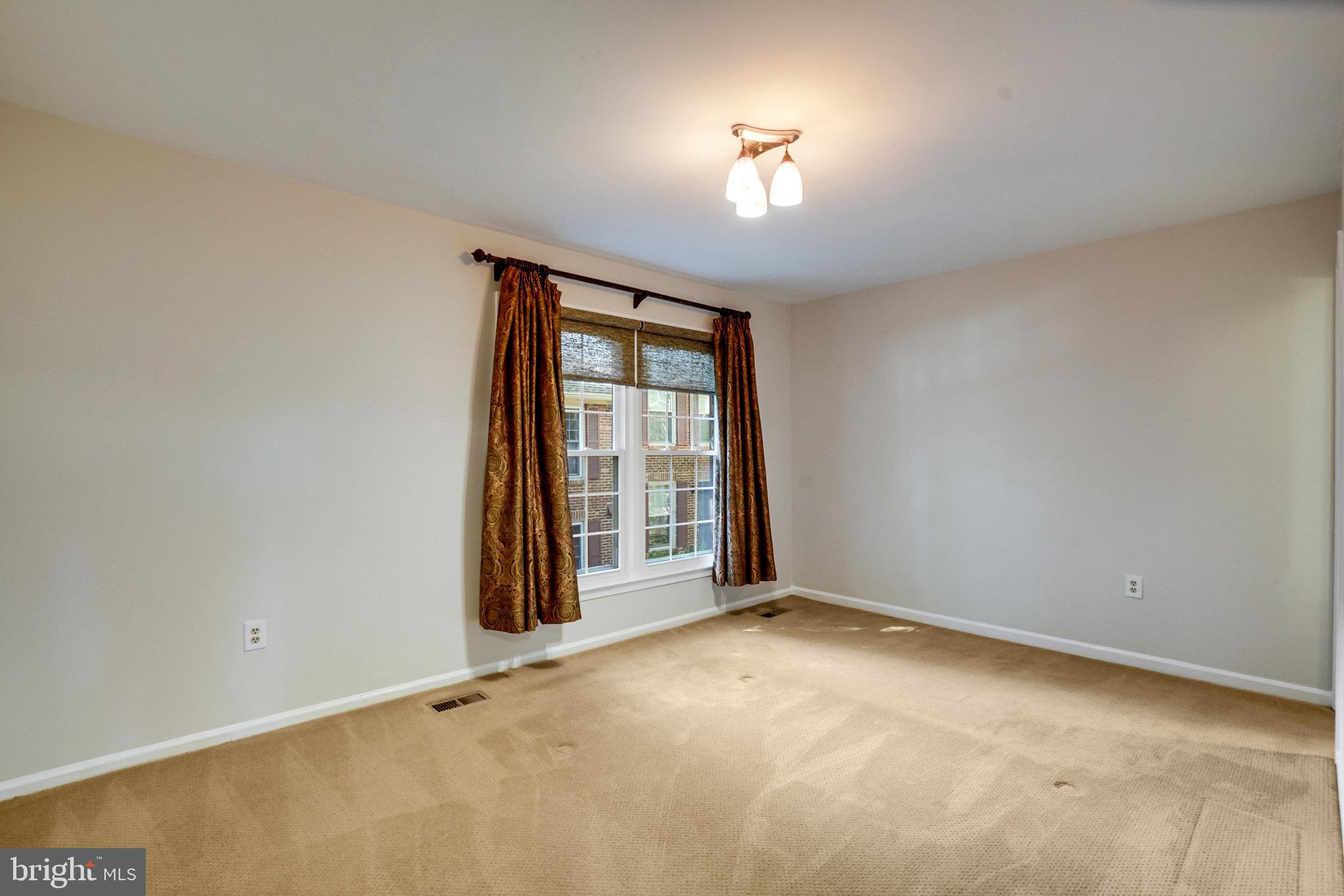 2540 South Walter Reed Drive, Unit 4 Arlington, VA 22206 - Photo 23 of 40 an empty room with a empty space and windows