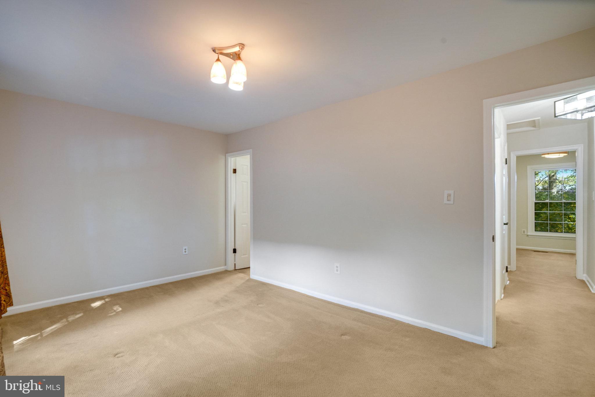 2540 South Walter Reed Drive, Unit 4 Arlington, VA 22206 - Photo 24 of 40 an empty room with closet and a chandelier fan