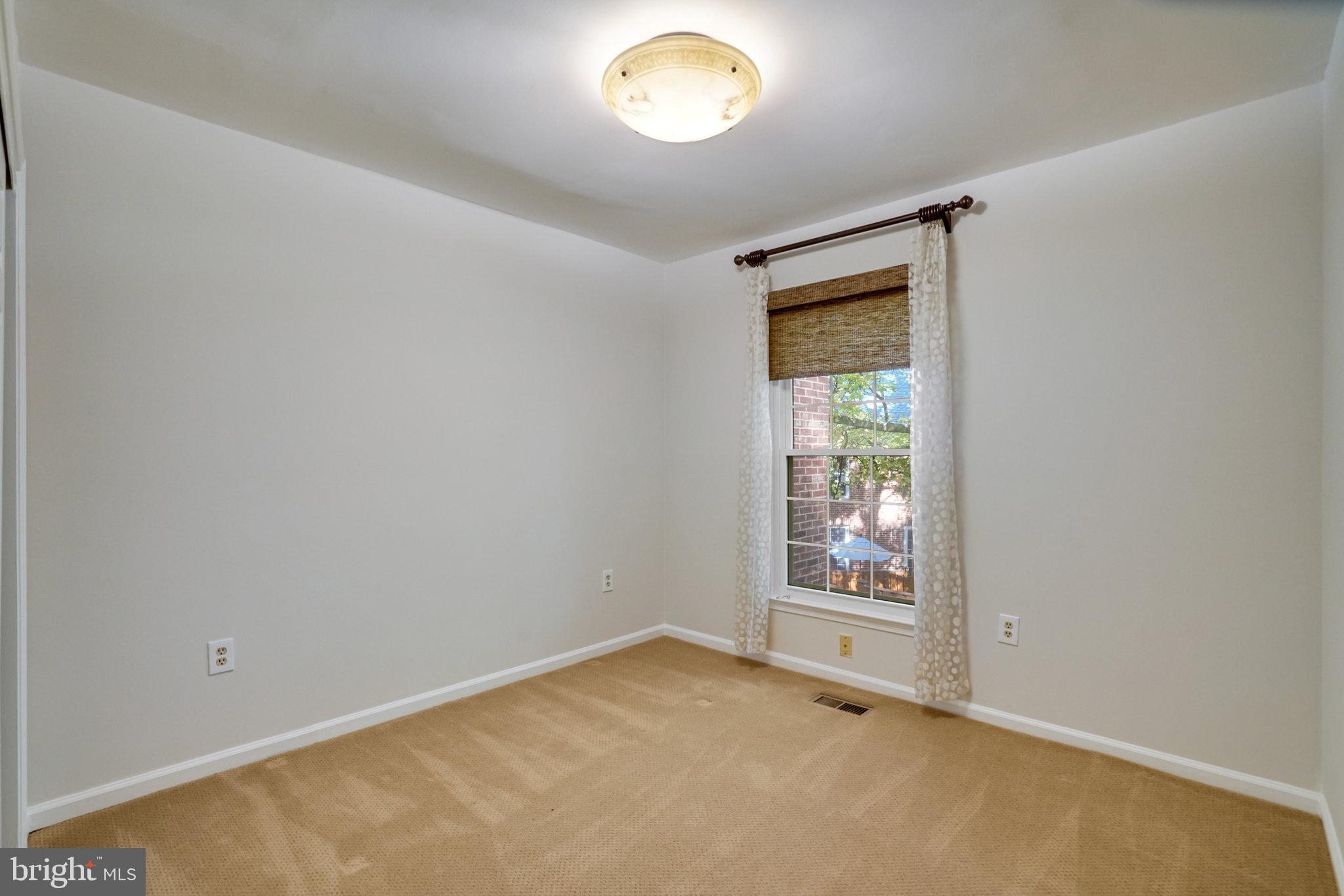 2540 South Walter Reed Drive, Unit 4 Arlington, VA 22206 - Photo 29 of 40 an empty room with a window