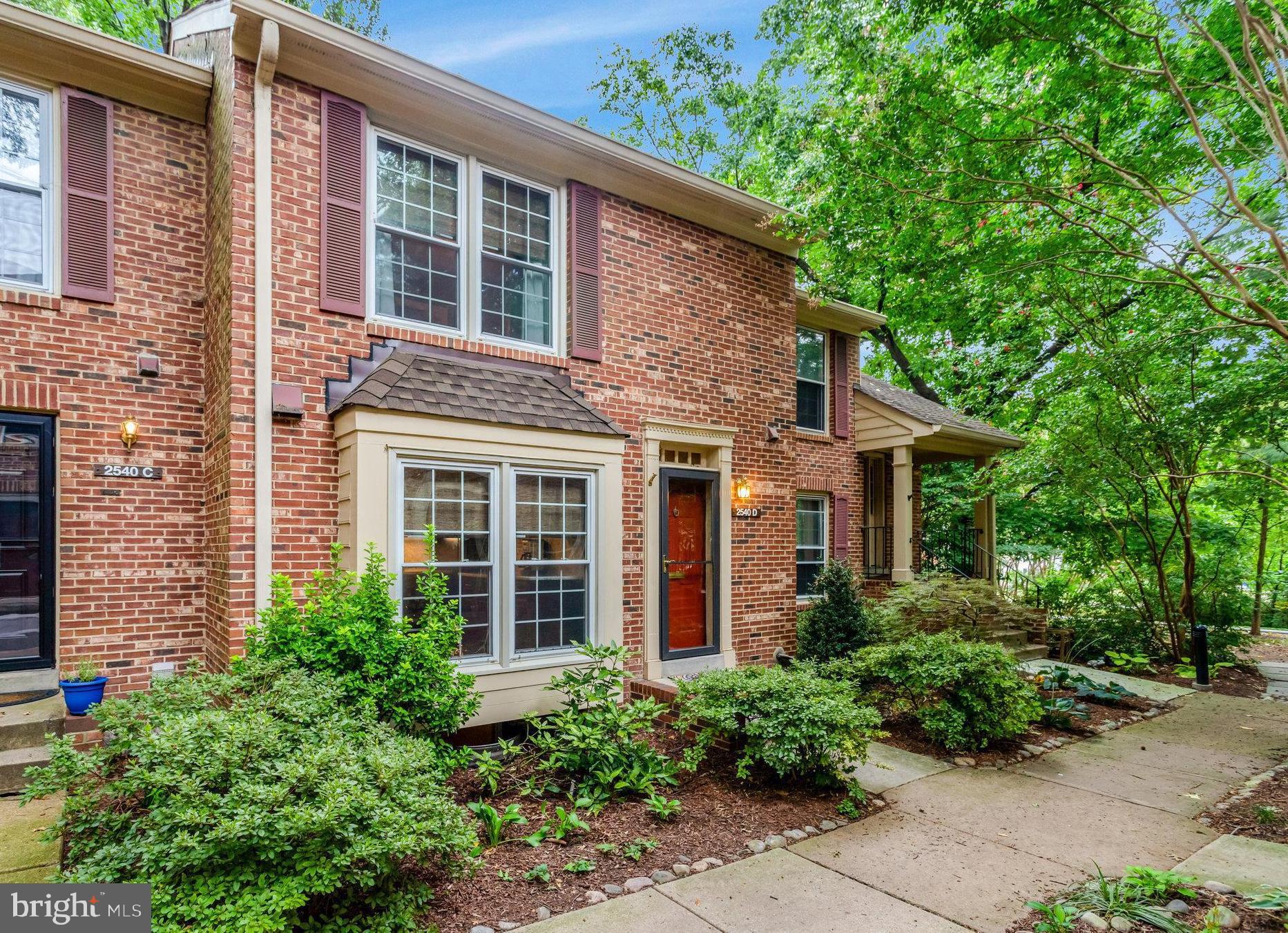 2540 South Walter Reed Drive, Unit 4 Arlington, VA 22206 - Photo 3 of 40 a view of a brick house with large windows and plants