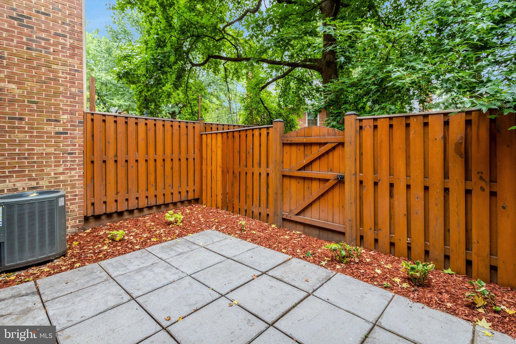 2540 South Walter Reed Drive, Unit 4 Arlington, VA 22206 - Photo 7 of 40 a view of a house with backyard and wooden fence