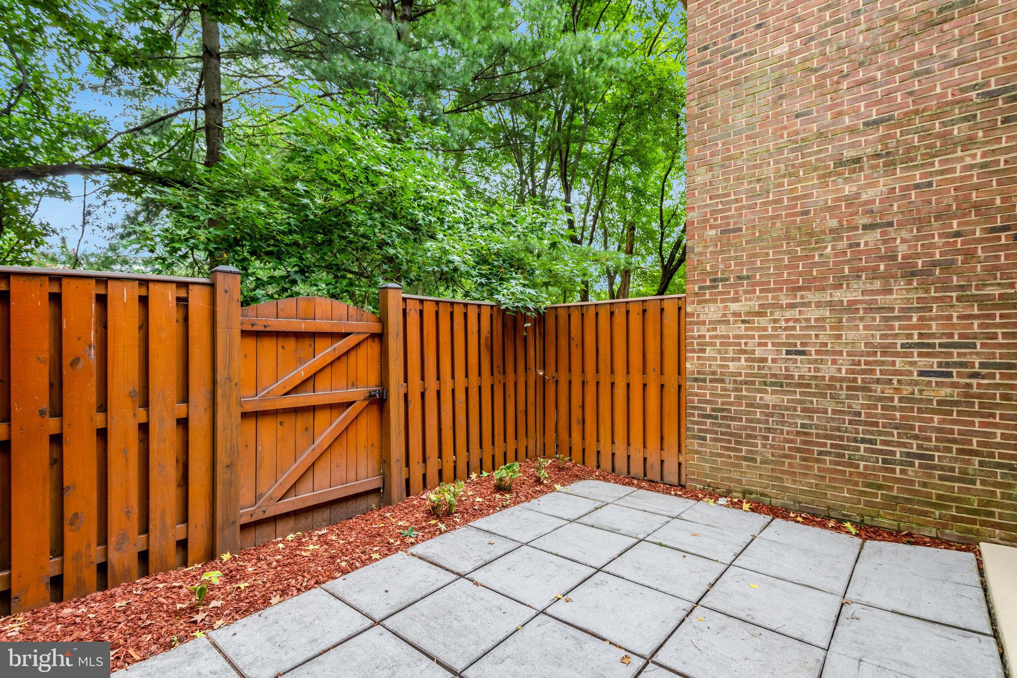 2540 South Walter Reed Drive, Unit 4 Arlington, VA 22206 - Photo 8 of 40 a view of a backyard with wooden fence