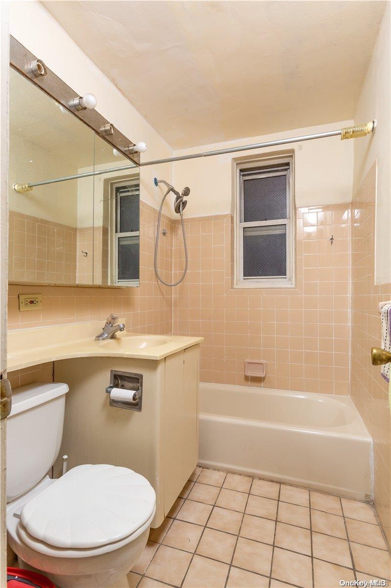 41-07 Bowne Street, Unit 3K Queens, NY 11355 - Photo 12 of 17 a bathroom with a sink a toilet and shower