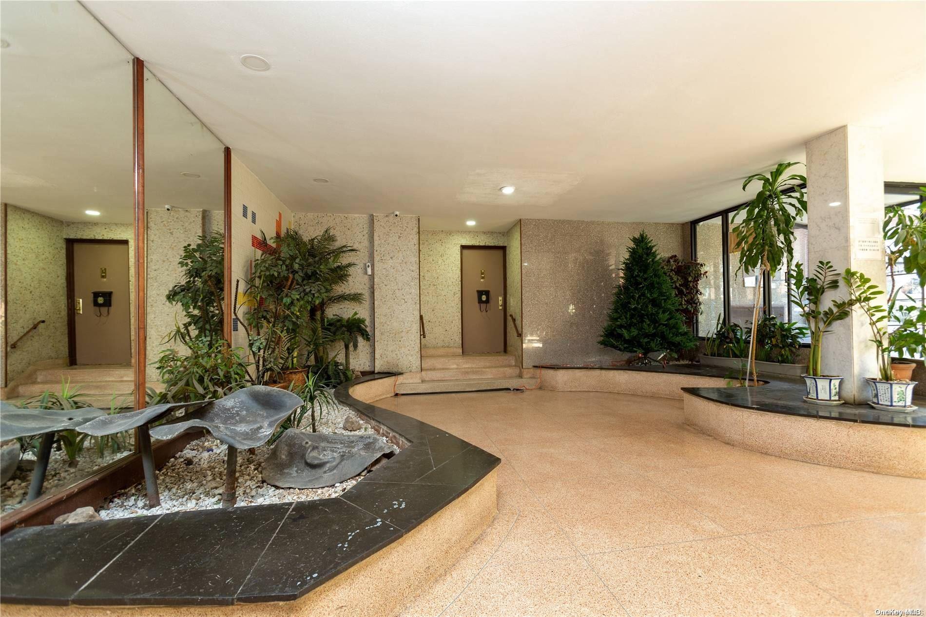 41-07 Bowne Street, Unit 3K Queens, NY 11355 - Photo 4 of 17 a living room with furniture and a large window