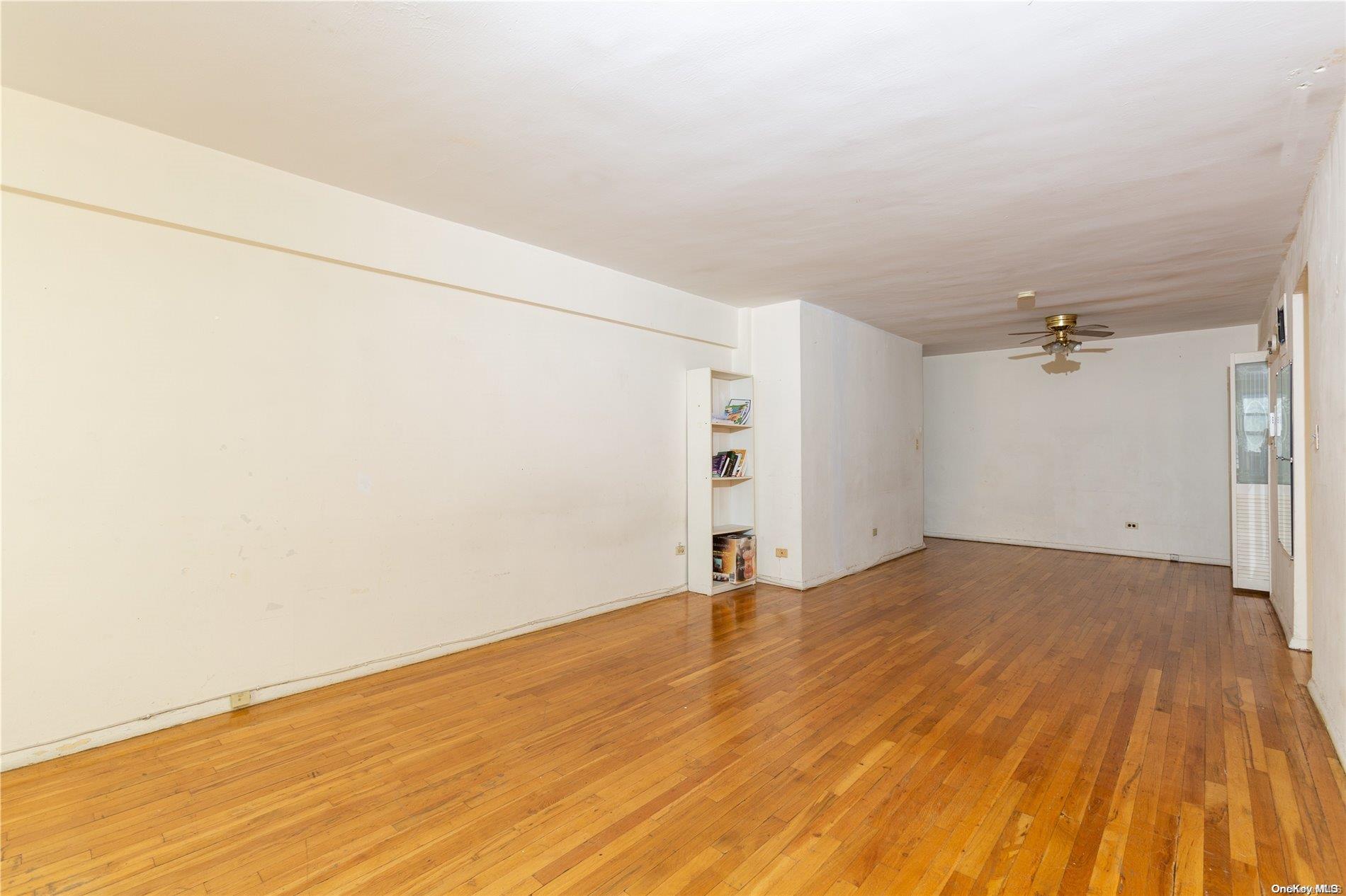 41-07 Bowne Street, Unit 3K Queens, NY 11355 - Photo 8 of 17 a view of empty room with wooden floor