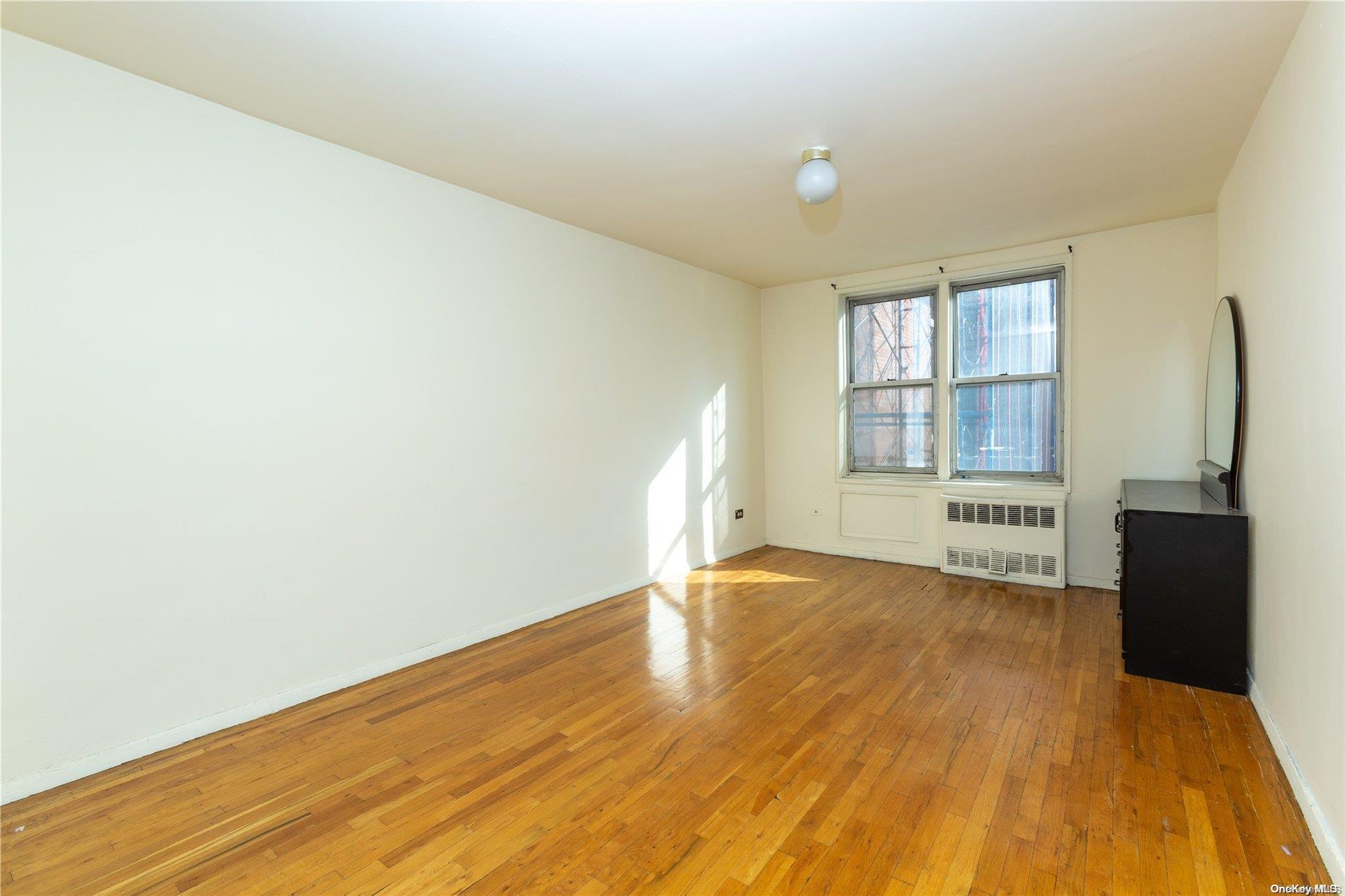 41-07 Bowne Street, Unit 3K Queens, NY 11355 - Photo 10 of 17 a view of an empty room with a window