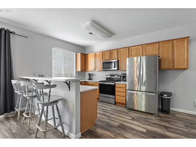 a kitchen with stainless steel appliances a refrigerator stove microwave and sink