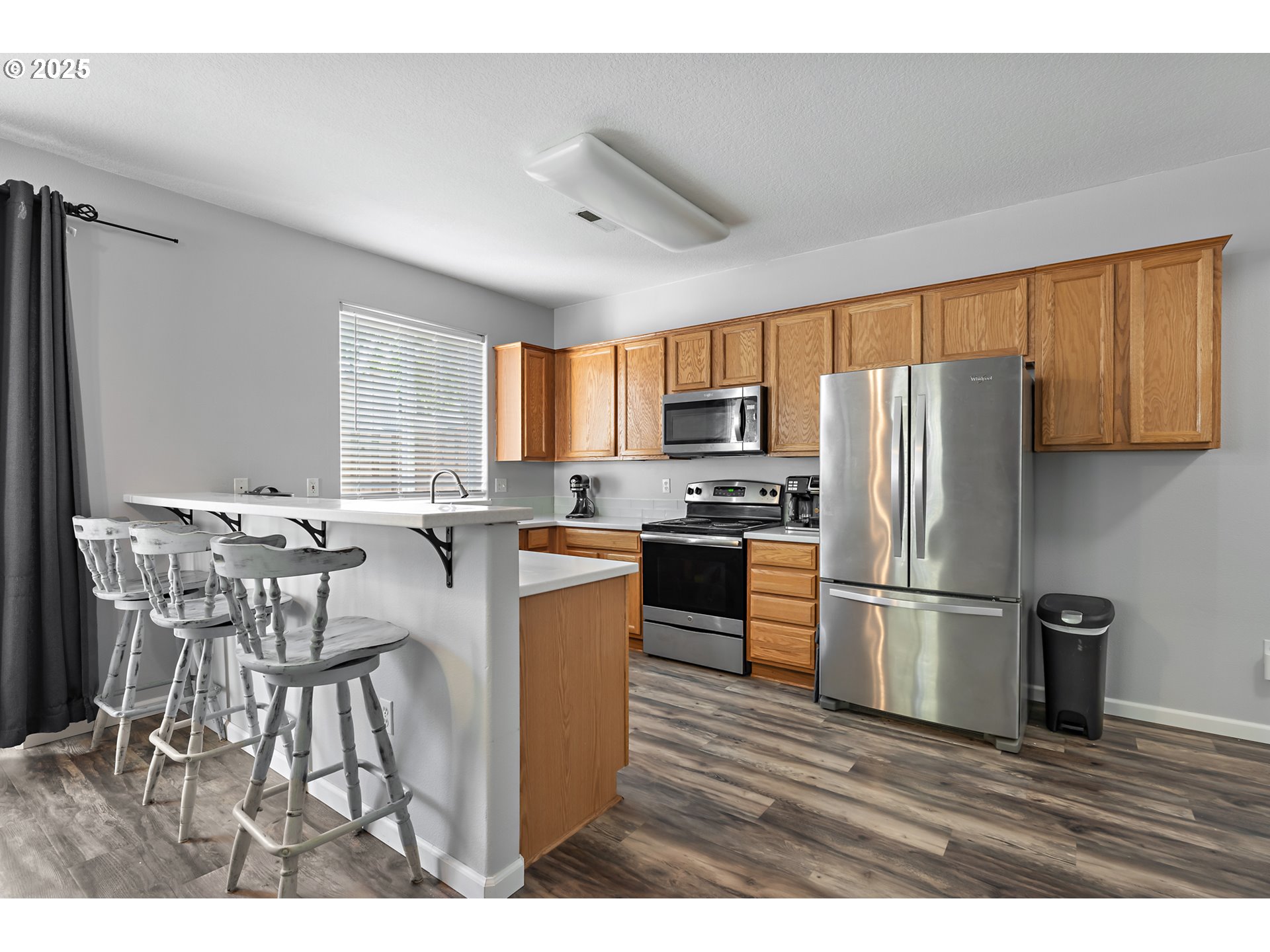 6255 Southwest 182nd Terrace Beaverton, OR 97007 - Photo 15 of 42 a kitchen with stainless steel appliances a refrigerator stove microwave and sink