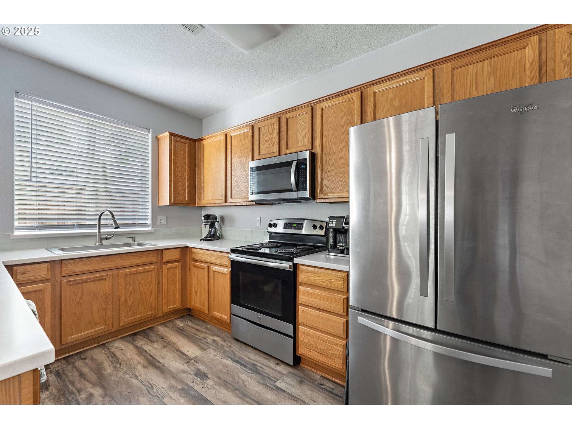 6255 Southwest 182nd Terrace Beaverton, OR 97007 - Photo 16 of 42 a kitchen with granite countertop a refrigerator and a sink