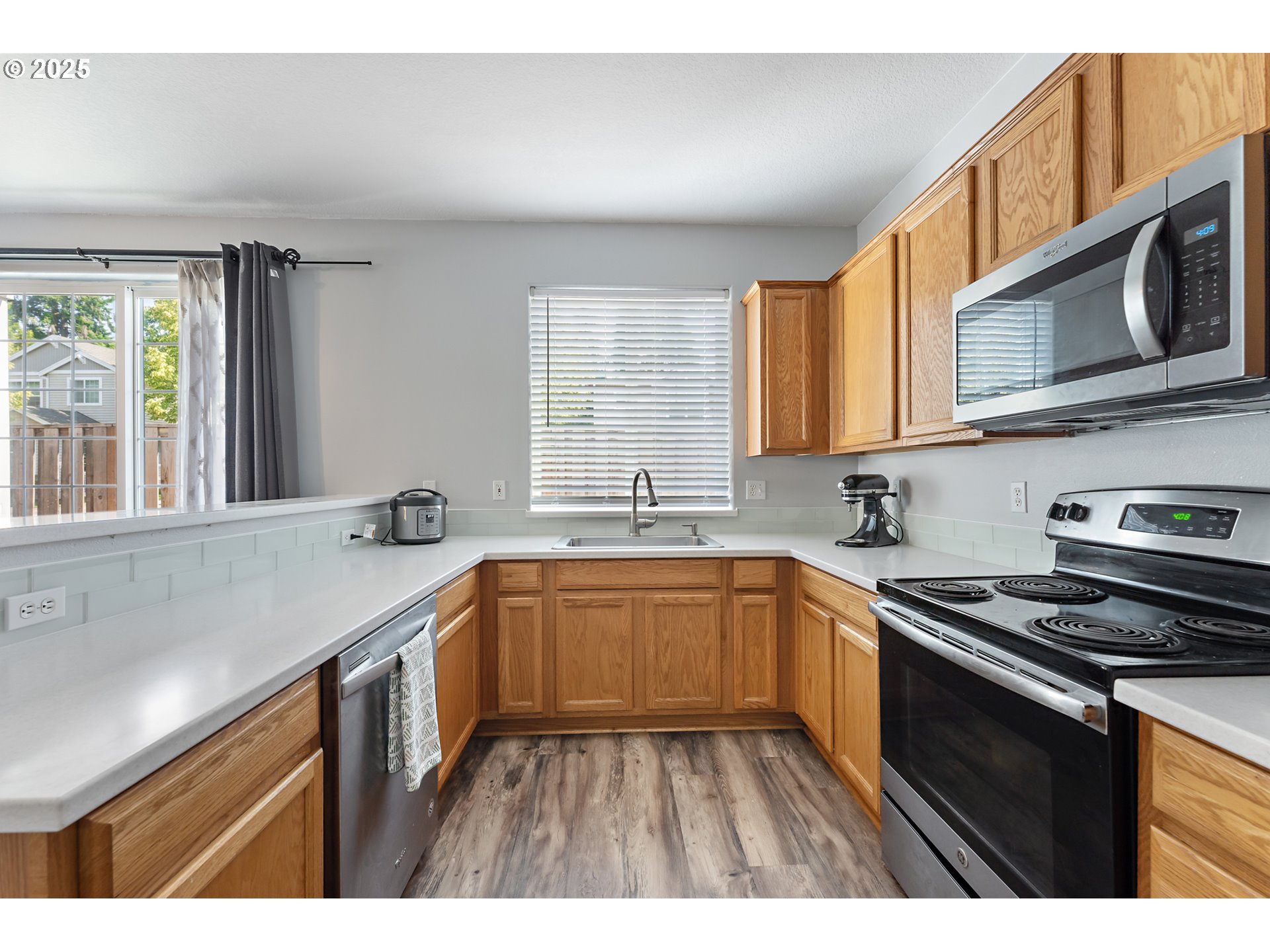 6255 Southwest 182nd Terrace Beaverton, OR 97007 - Photo 19 of 42 a kitchen with stainless steel appliances granite countertop a sink stove and cabinets