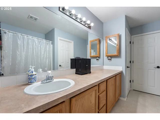 a bathroom with a double vanity sink and mirror