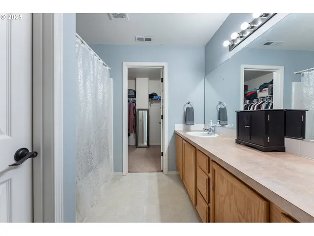 a view of walk in closet with clothes