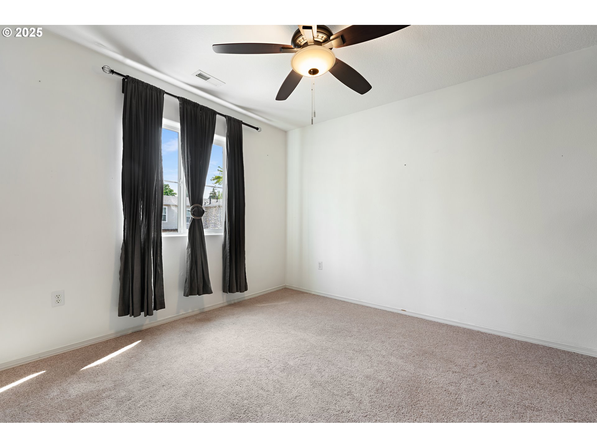 6255 Southwest 182nd Terrace Beaverton, OR 97007 - Photo 32 of 42 an empty room with ceiling fan and window