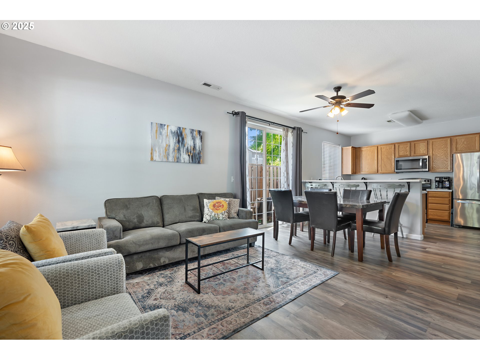 6255 Southwest 182nd Terrace Beaverton, OR 97007 - Photo 7 of 42 a living room with furniture and a dining table with wooden floor
