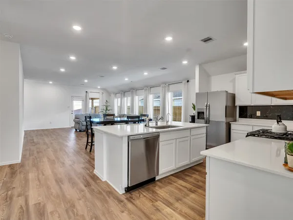 a kitchen with refrigerator and cabinets