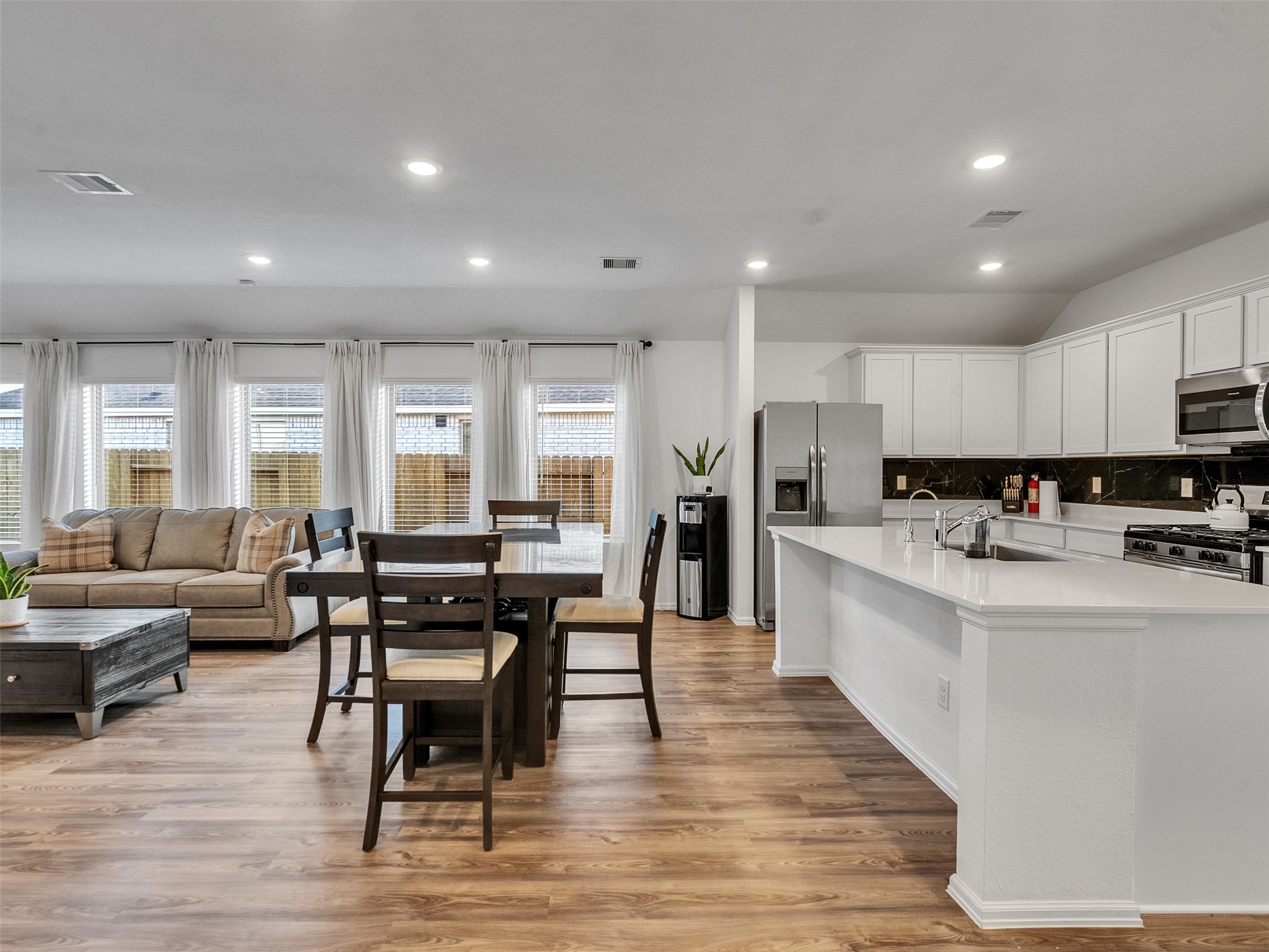 3019 Live Spgs Way Rosenberg, TX 77471 - Photo 15 of 36 a living room with stainless steel appliances kitchen island granite countertop a dining table chairs stove a refrigerator and cabinets
