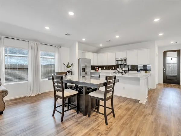 a view of a dining room with furniture and wooden floor