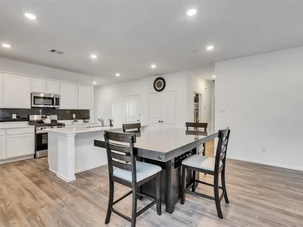a kitchen with a table and chairs in it