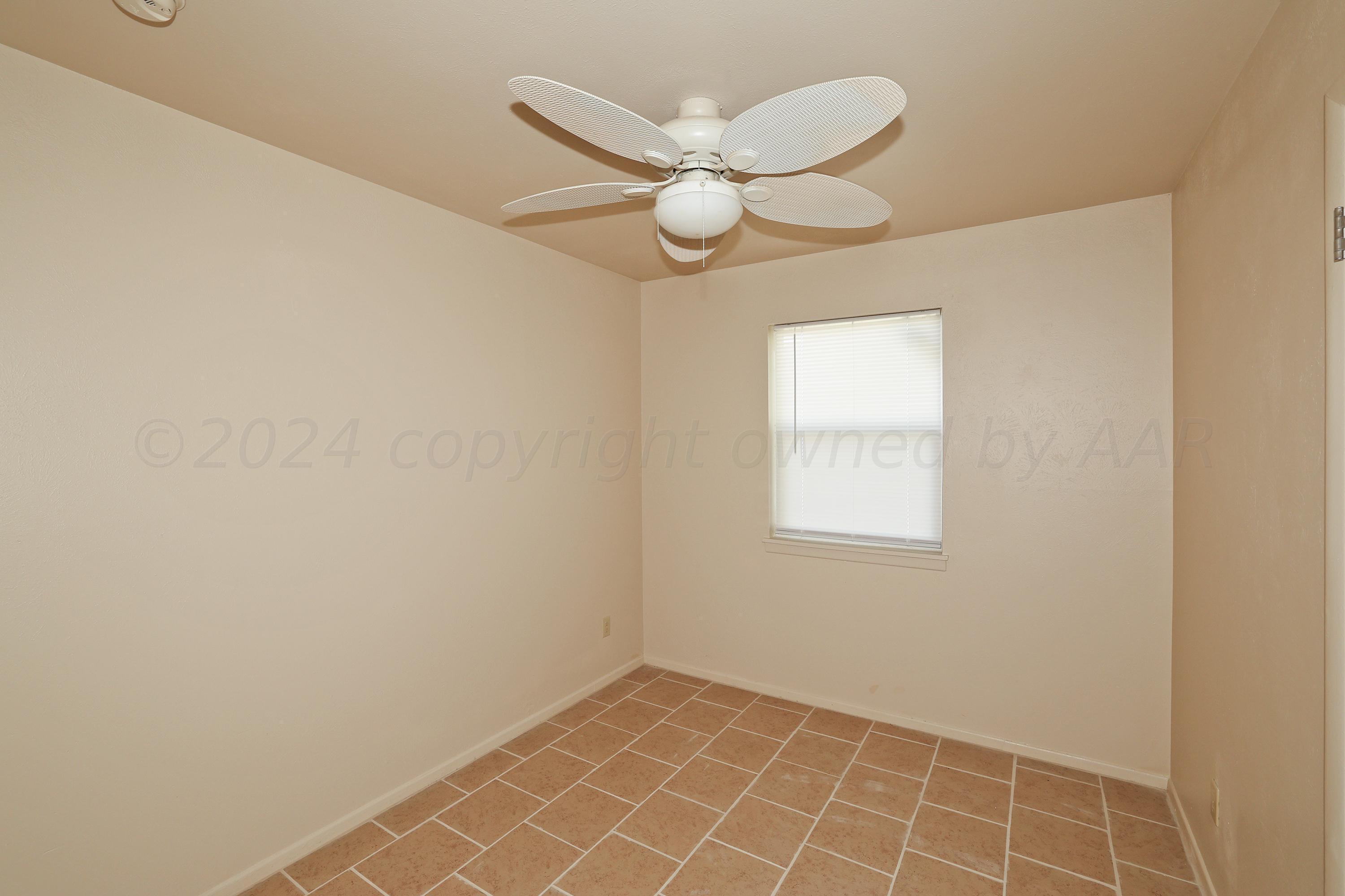 1232 Sycamore Avenue Amarillo, TX 79107 - Photo 15 of 19 an empty room with a fan & a window