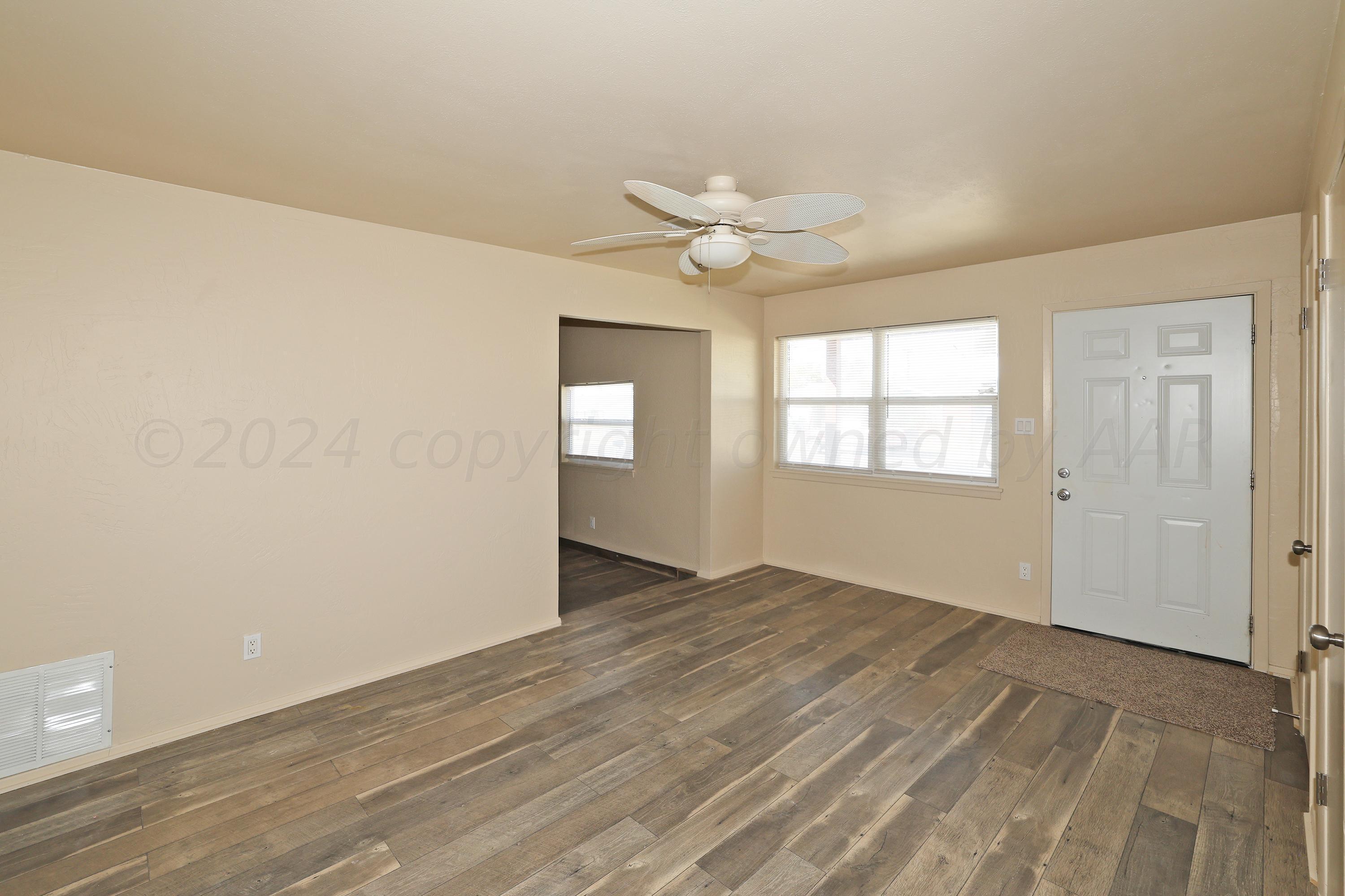 1232 Sycamore Avenue Amarillo, TX 79107 - Photo 3 of 19 wooden floor in an empty room with a window