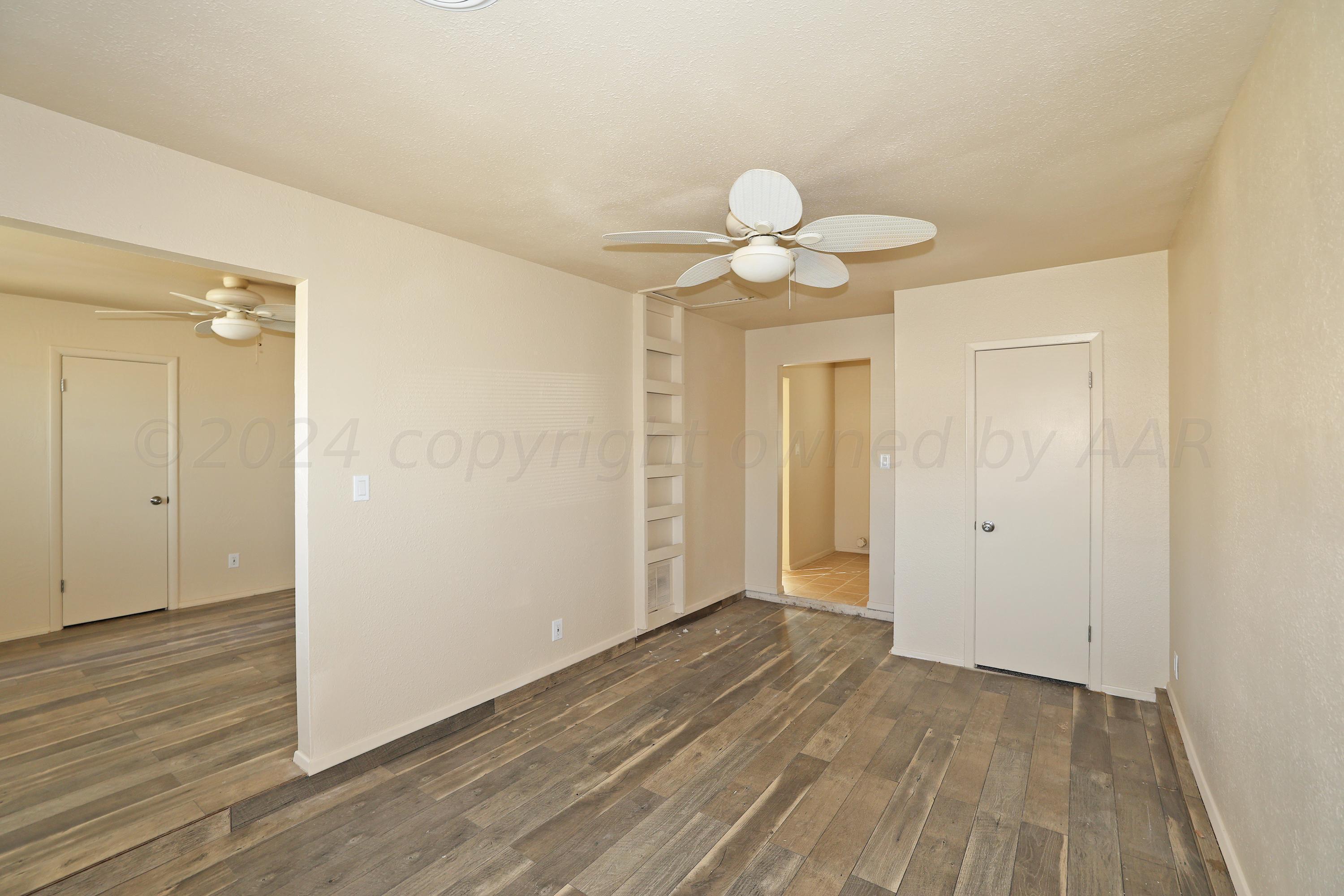 1232 Sycamore Avenue Amarillo, TX 79107 - Photo 4 of 19 a view of an empty room and wooden floor