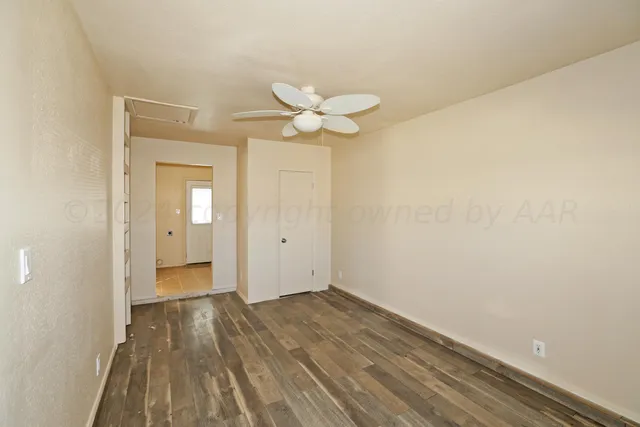 a view of a room with a sink and a chandelier fan