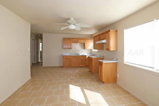 a view of a kitchen with a sink and a window