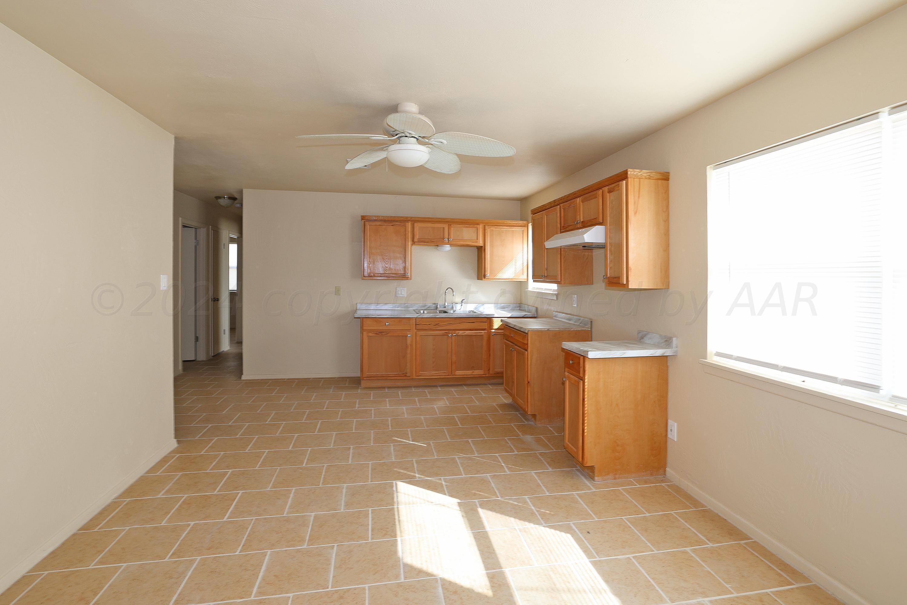1232 Sycamore Avenue Amarillo, TX 79107 - Photo 7 of 19 a view of a kitchen with a sink and a window