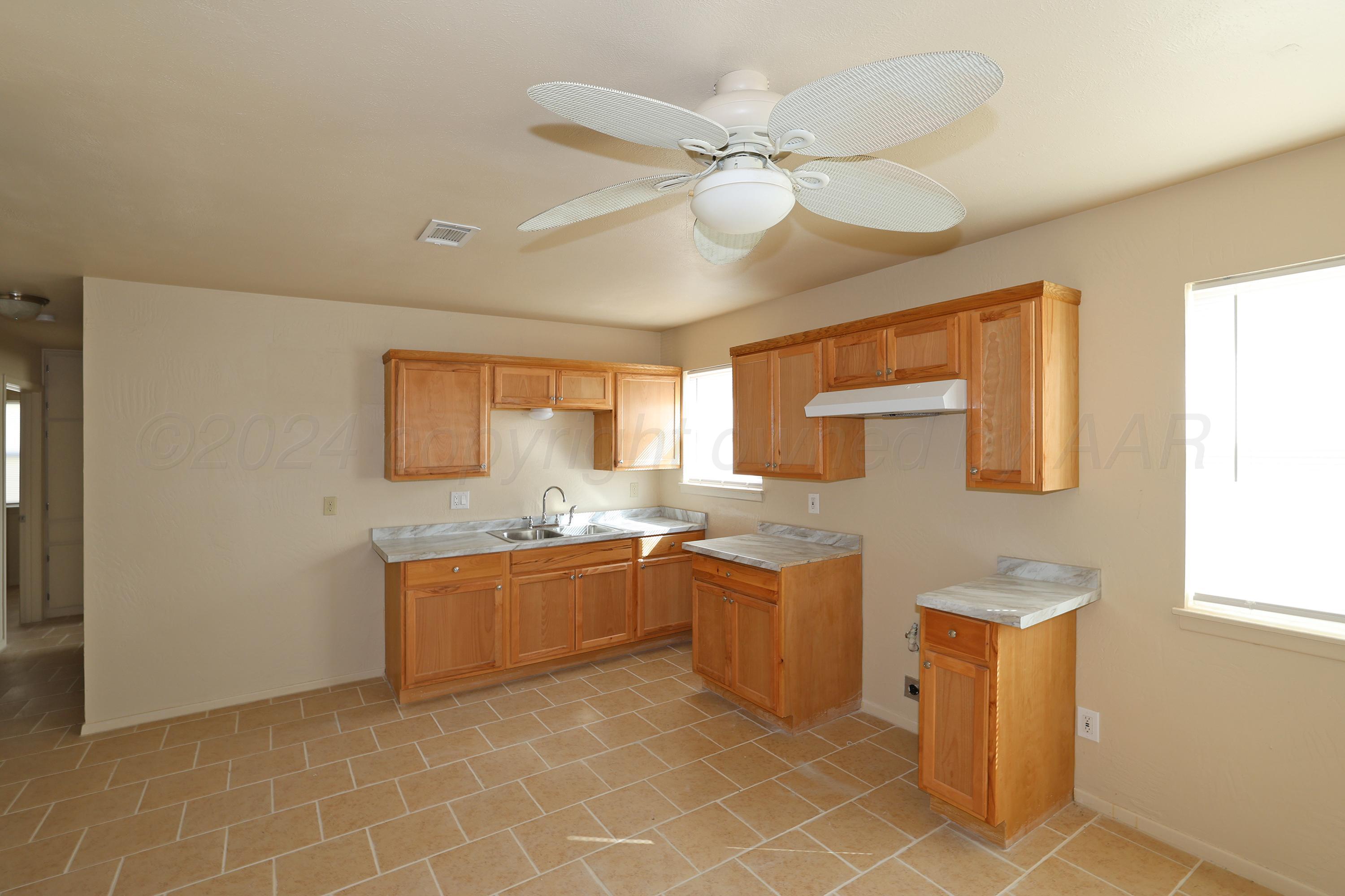 1232 Sycamore Avenue Amarillo, TX 79107 - Photo 8 of 19 a kitchen with stainless steel appliances granite countertop a sink and a refrigerator