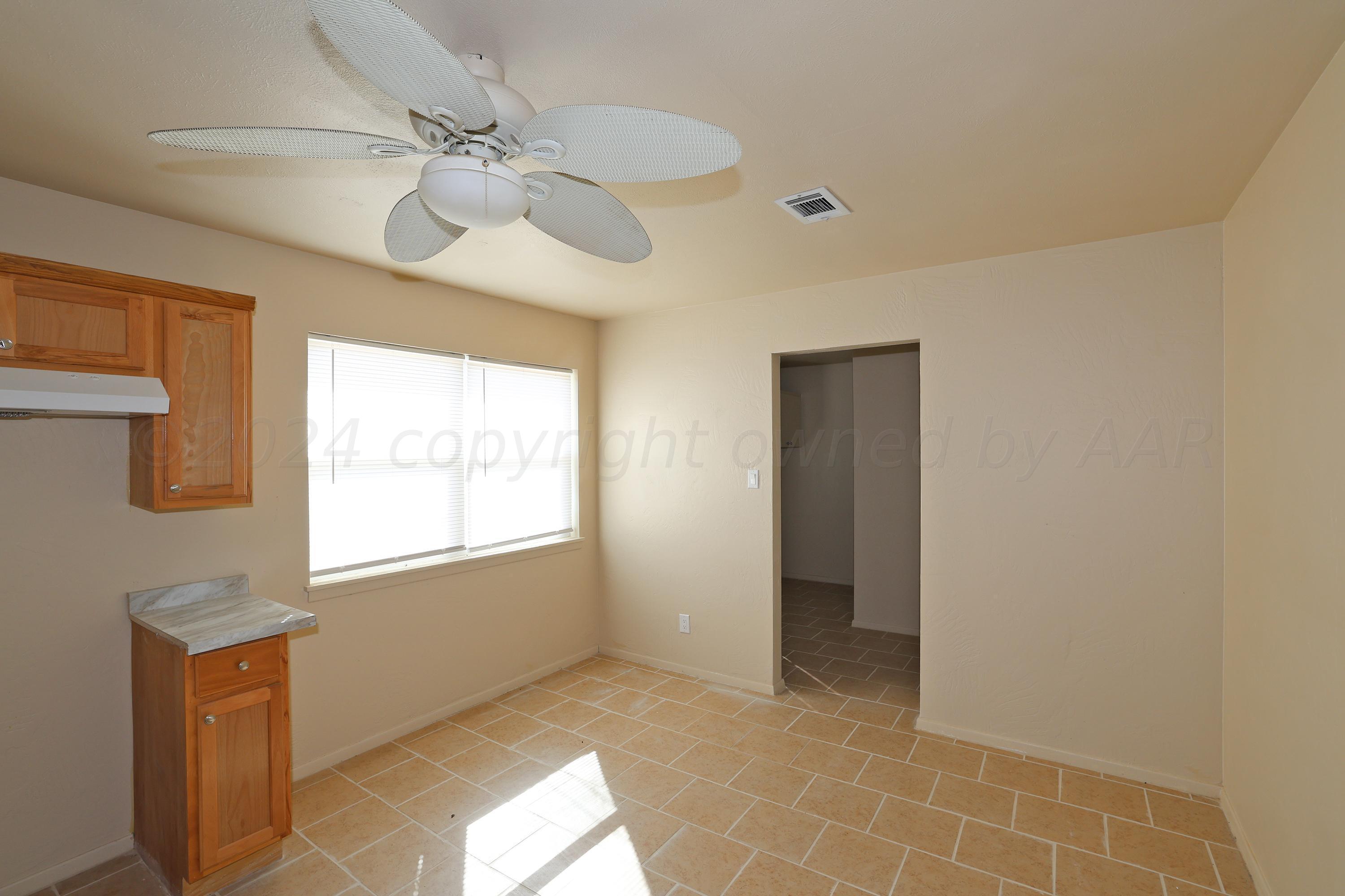 1232 Sycamore Avenue Amarillo, TX 79107 - Photo 9 of 19 a view of an empty room with a window