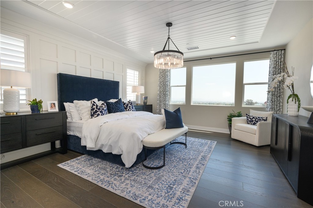 13093 Edgware Drive Rancho Cucamonga, CA 91739 - Photo 14 of 25 a bed room with furniture and a chandelier