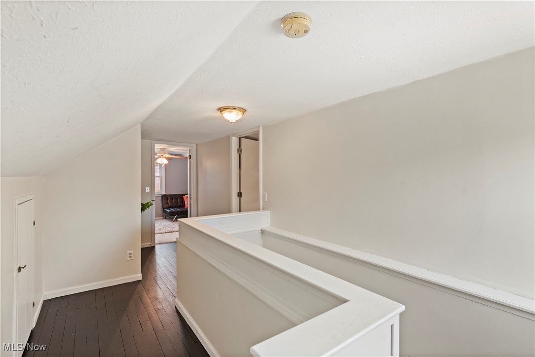 1271 Lander Road Cleveland, OH 44124 - Photo 18 of 37 Hardwood floors continue up the stairs to the second floor. The landing’s angled ceilings highlight the iconic design elements of a vintage-modern residence.