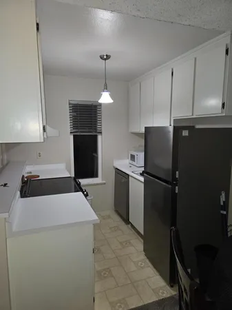 a kitchen with a refrigerator a stove and a sink