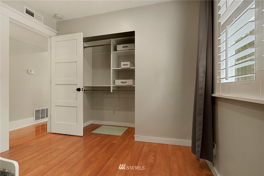 18 218th Place Southeast Bothell, WA 98021 - Photo 17 of 34 a view of an empty room with wooden floor and a window