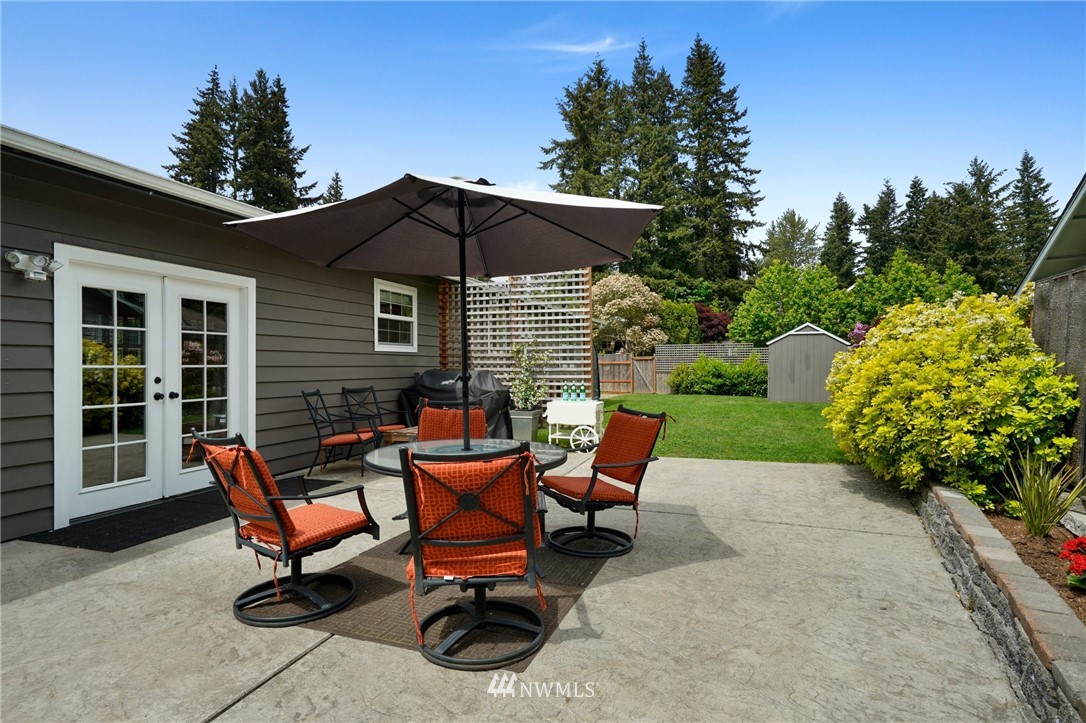 18 218th Place Southeast Bothell, WA 98021 - Photo 5 of 34 a view of a patio with a table and chairs under an umbrella