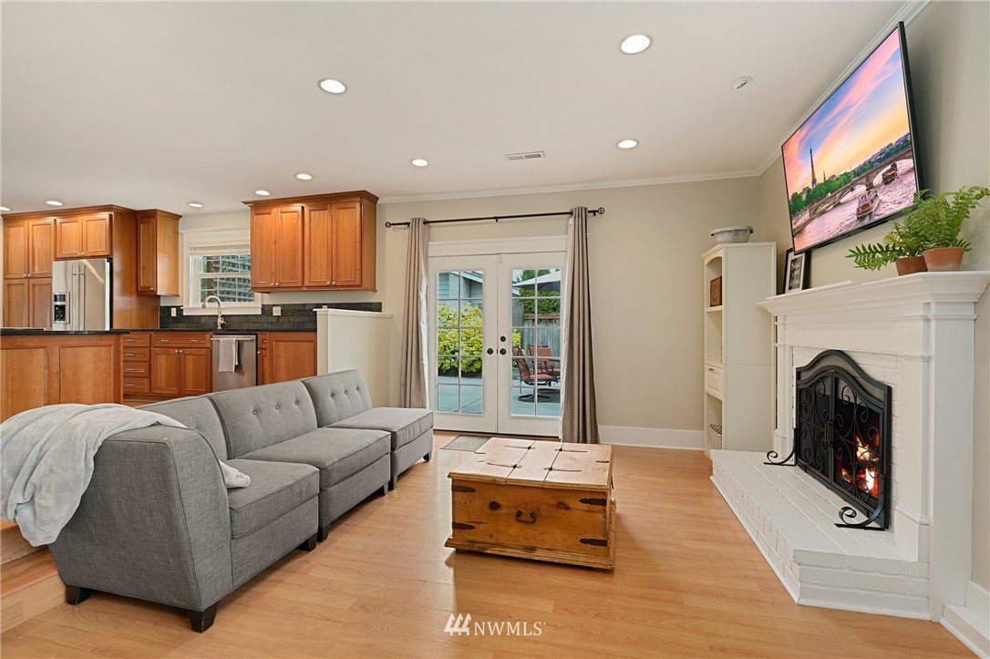 18 218th Place Southeast Bothell, WA 98021 - Photo 7 of 34 a living room with furniture a fireplace and a flat screen tv