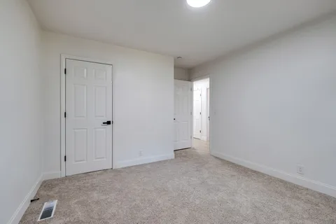 a view of an empty room and entryway