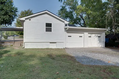 a backyard of a house with outdoor seating