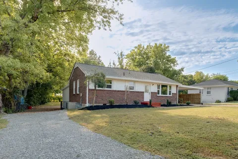 a view of a house with swimming pool and sitting area