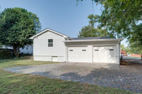 a view of a yard with trees in the background