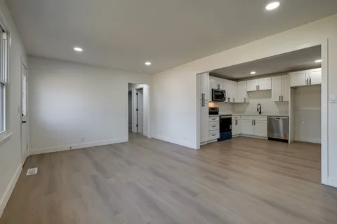 a view of a kitchen with a sink and a stove top oven