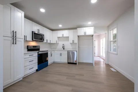 a kitchen with a refrigerator a stove top oven a sink and dishwasher