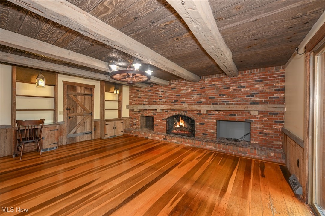 7031 Beach Road Medina, OH 44256 - Photo 13 of 27 The family room features beamed ceilings, a brick
wood burning fireplace ans built ins.