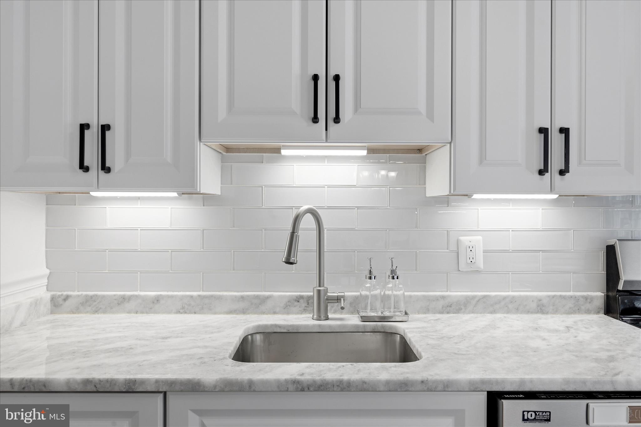 5446 Lighthouse Lane Burke, VA 22015 - Photo 9 of 36 a kitchen with granite countertop a sink and cabinets
