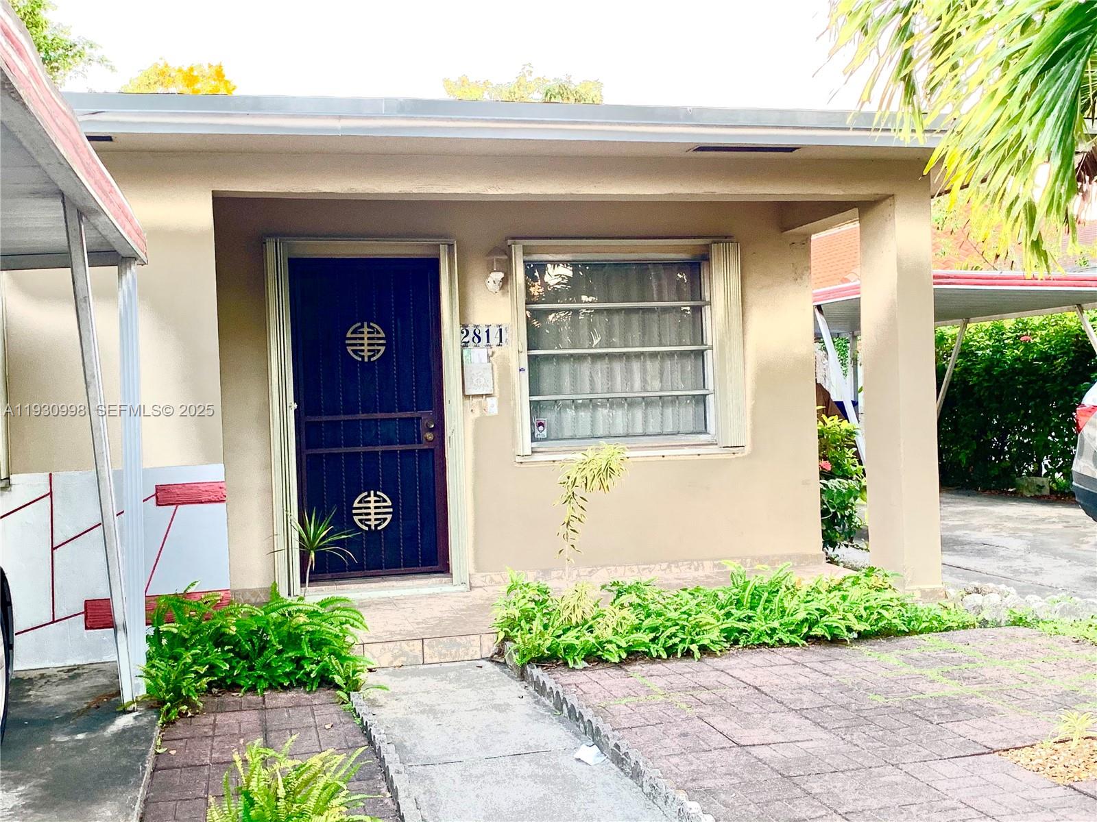 2814 Southwest 7th Street, Unit 2814 Miami, FL 33135 - Photo 2 of 13 a front view of a house with garden