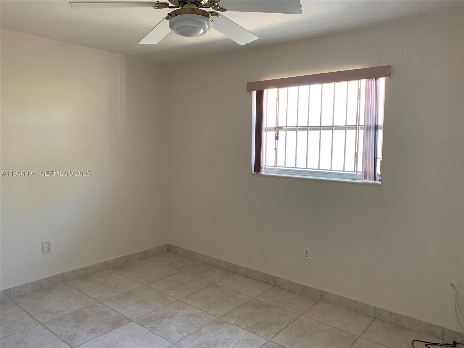 2814 Southwest 7th Street, Unit 2814 Miami, FL 33135 - Photo 6 of 13 an empty room with a window