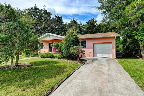 a front view of house with yard and green space